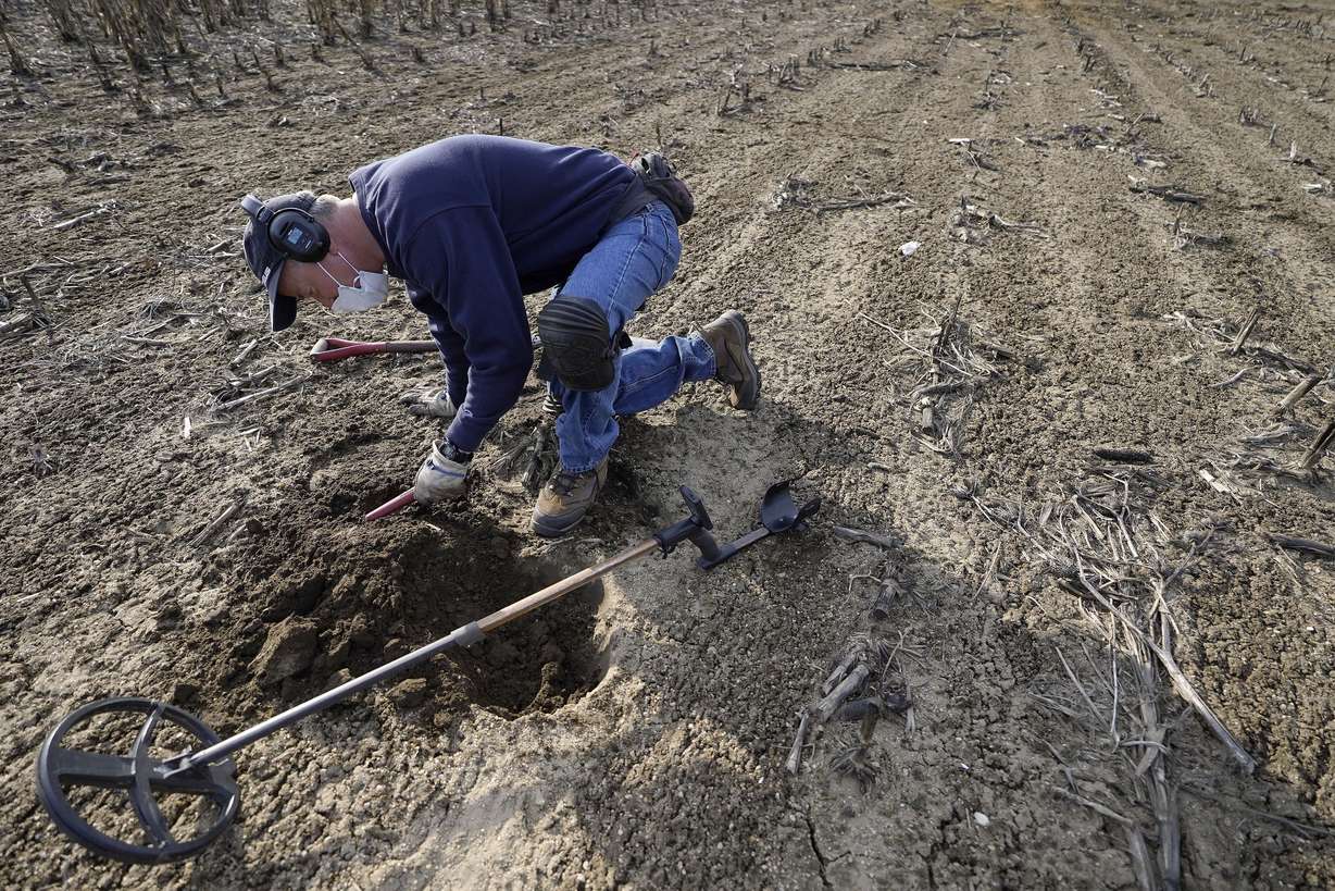 Metal detectorist Jim Bailey scans dirt for Colonial-era artifacts in a field, Thursday, March 11, 2021, in Warwick, R.I. Bailey, who holds a degree in anthropology from the University of Rhode Island, found a 17th-century Arabian silver coin in 2014 at a farm, in Middletown, R.I., that he contends was plundered in 1695 by English pirate Henry Every from Muslim pilgrims sailing home to India after a pilgrimage to Mecca.