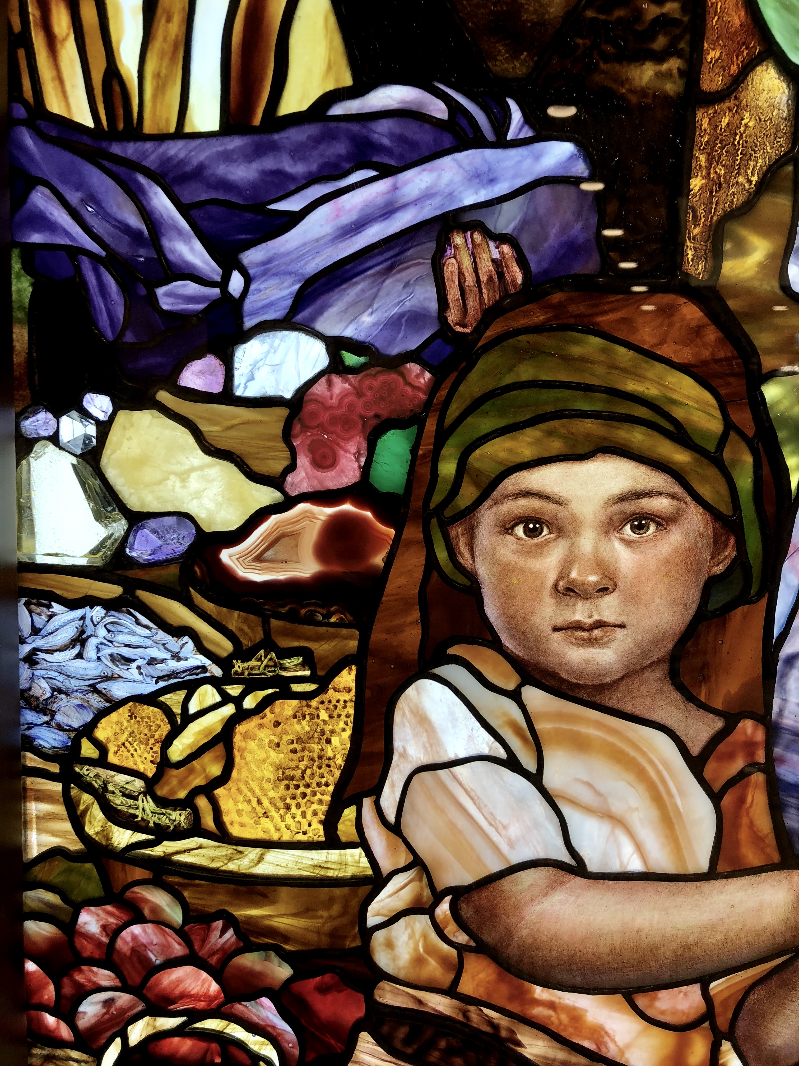 Purposeful artistic thought and symbols (even some Easter eggs) within Holdman Studios' stained glass images of Christ