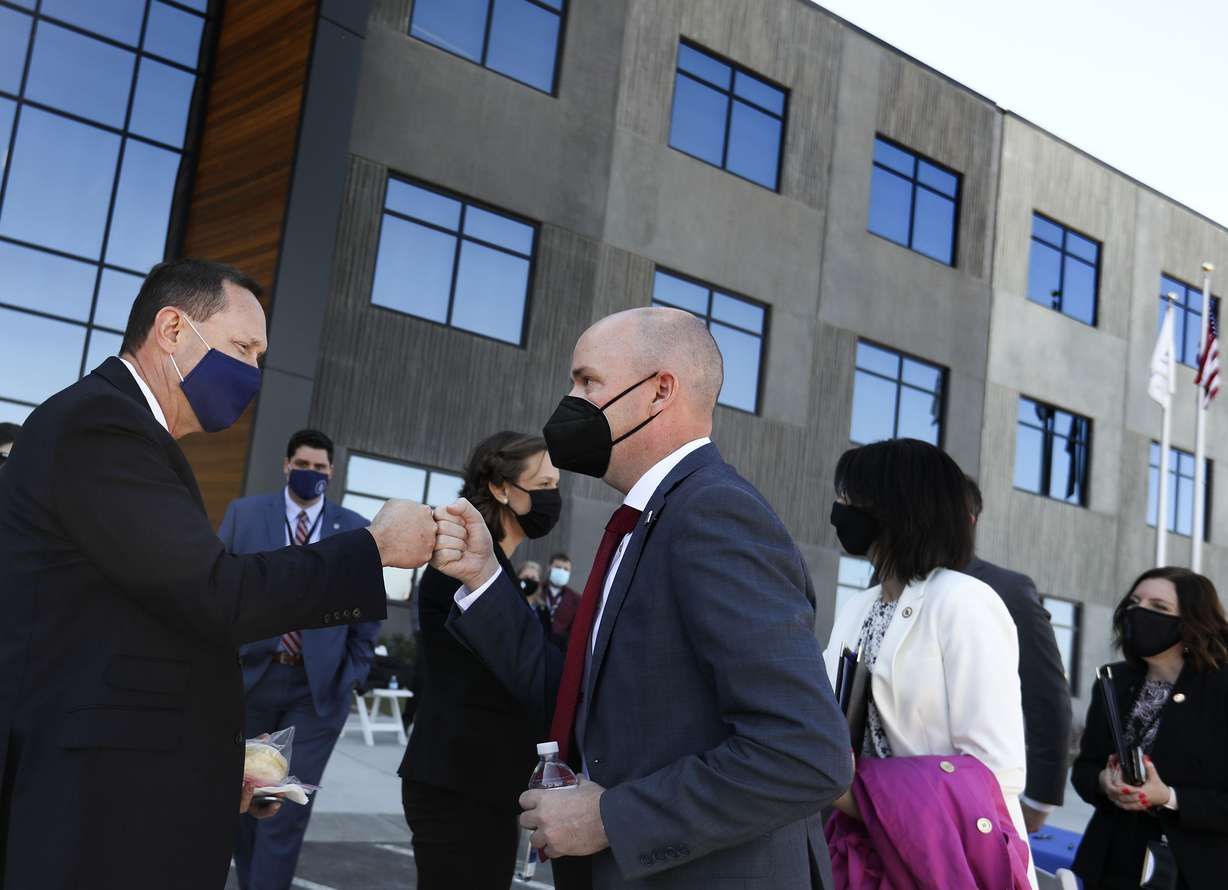 Greg Manuel, vice president and general manager of the strategic deterrent systems division at Northrop Grumman, left, and Gov. Spencer Cox bump fists after a press conference outside of the Northrop Grumman in Roy on Thursday, April 1, 2021, where the launch of Lt. Gov. Deidre Henderson's new returnship initiative was announced.