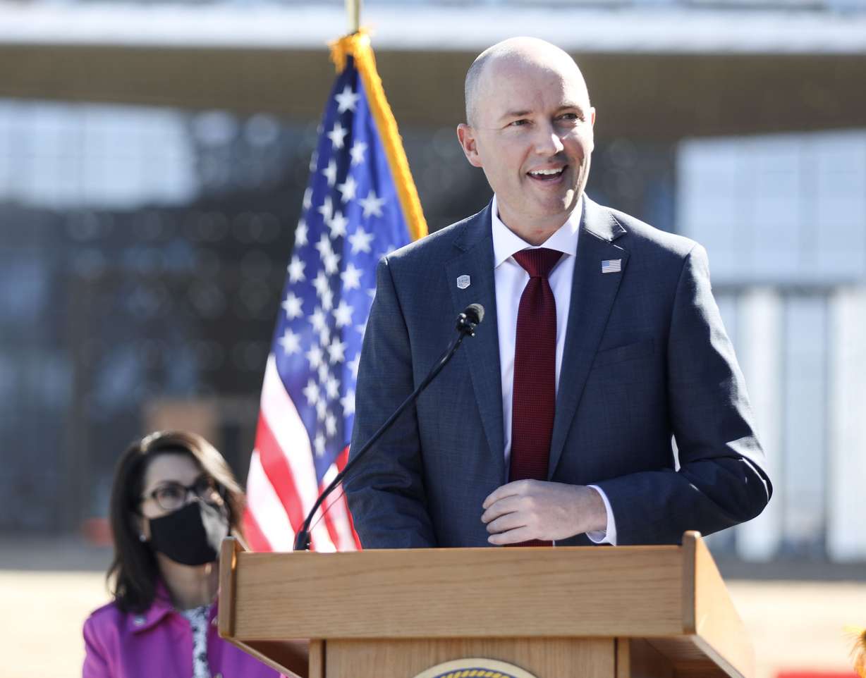 Lt. Gov. Deidre Henderson, left, listens as Gov. Spencer Cox speaks during a weekly COVID-19 briefing outside of the Northrop Grumman offices in Roy on Thursday, April 1, 2021.