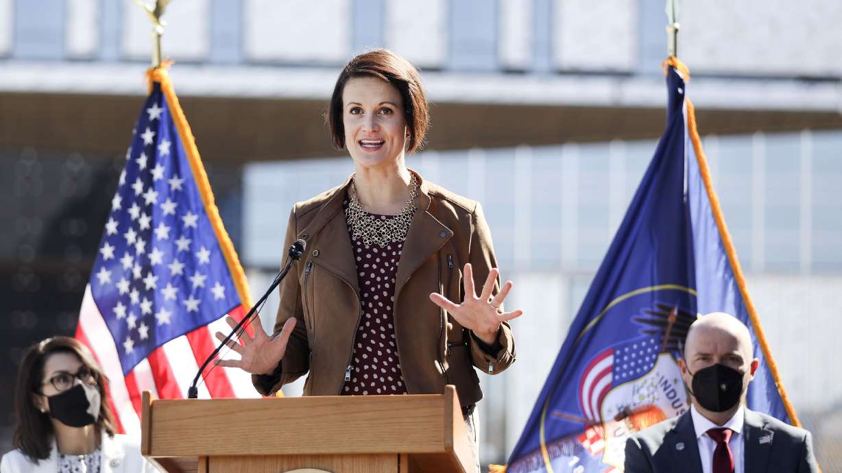 Lt. Gov. Deidre Henderson, left, and Gov. Spencer Cox, right, listen as state epidemiologist Dr. Angela Dunn speaks during a weekly COVID-19 briefing outside of Northrop Grumman's offices in Roy on Thursday, April 1, 2021.