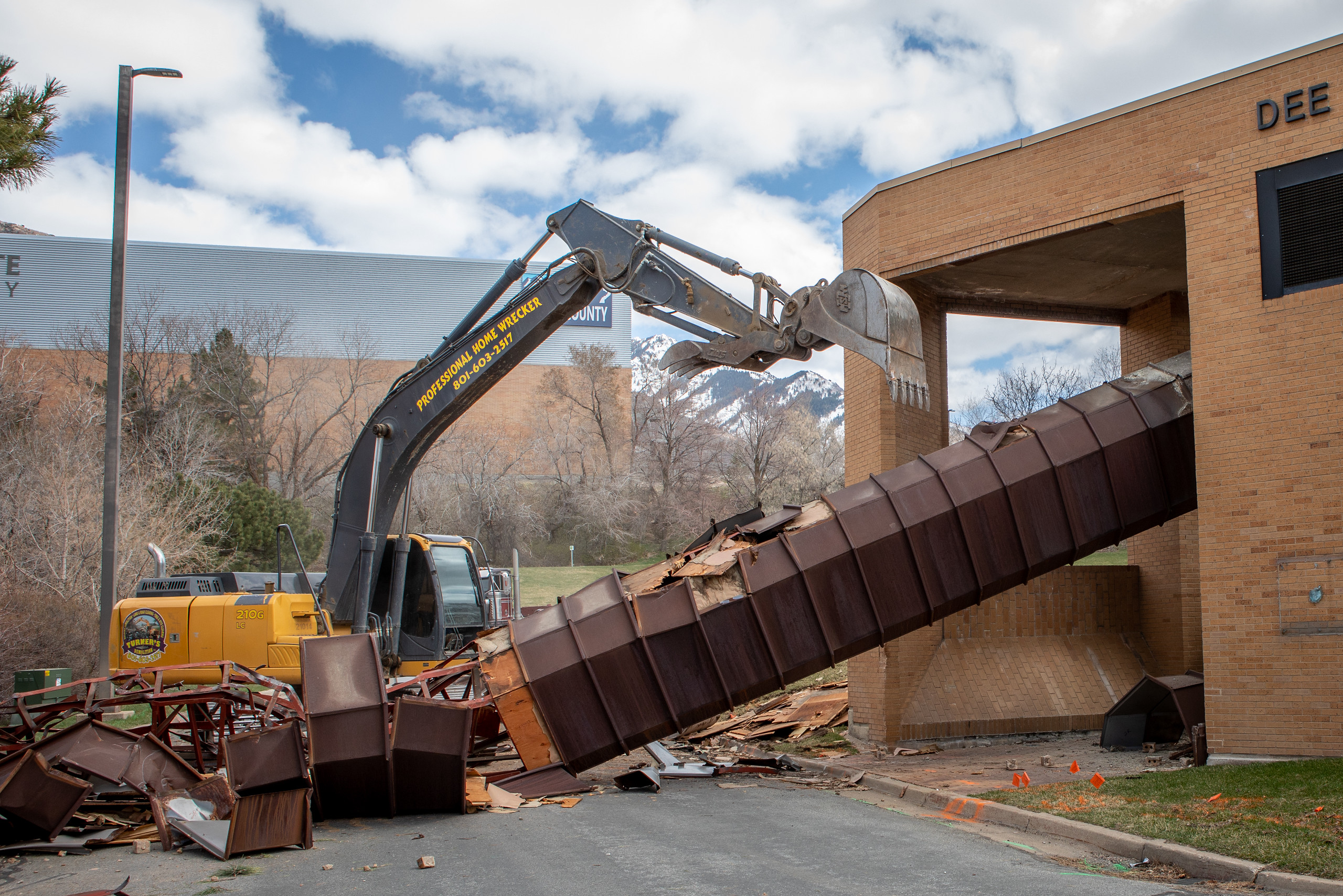 Crews demolish the old marquee at the entrance to the Dee Events Center to make way for the Bus Rapid Transit line at Weber State University on March 30, 2021. The BRT will eventually connect Weber State and McKay Dee with Downtown Ogden and the FrontRunner Station.