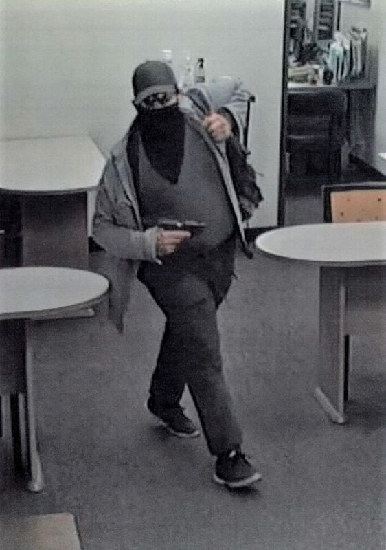 A suspect holding a weapon is seen in a still image from surveillance camera video taken inside the office of a mobile home realty company which was the scene of a mass shooting in Orange, California, U.S. March 31, 2021. Orange Police Department/Handout via REUTERS.