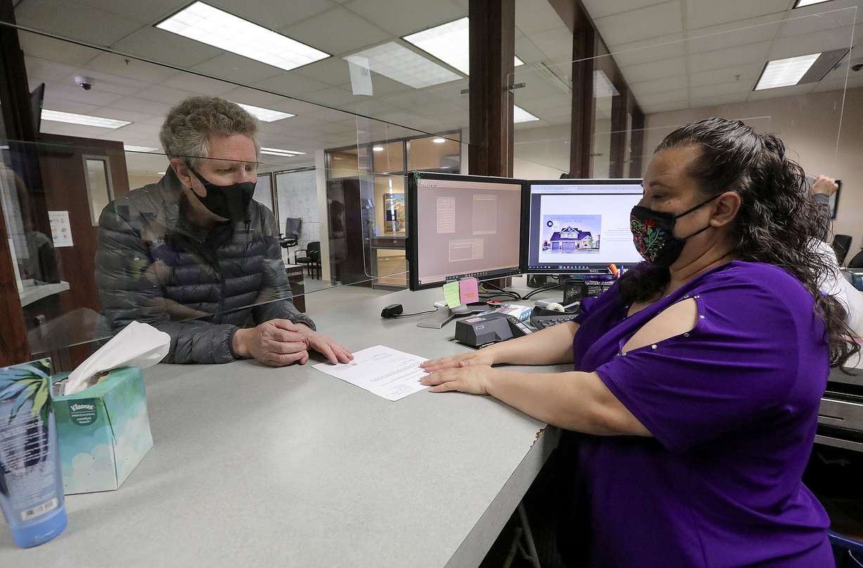 Val Johnson gets a copy of an affidavit voiding discriminating language on a covenant attached to a deed to a property he owns from to Erica Romero, a supervisor in the Salt Lake County Recorder’s Office, in Salt Lake City on Friday, April 2, 2021.
Val Johnson gets a copy of an affidavit voiding discriminating language on a covenant attached to a deed to a property he owns from to Erica Romero, a supervisor in the Salt Lake County Recorder’s Office, in Salt Lake City on Friday, April 2, 2021.