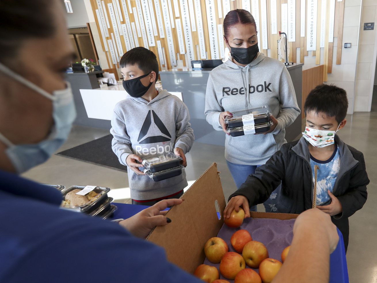 A family grabs dinner at Neighborhood House in Salt Lake City on March 30, 2021. Utah will receive a summer round of pandemic food assistance, bringing $375 per child to families in need.