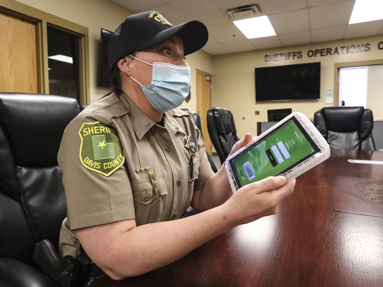 Davis County Sheriff’s Lt. DeeAnn Servey holds a tablet
that is issued to inmates when they’re booked into jail while
discussing the benefits of the device during an interview at the
Farmington facility on Thursday, March 18, 2021.