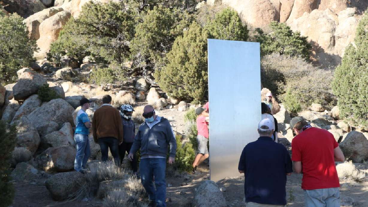 Hikers and UTV riders visit the site of a metal sculpture in Three Peaks Recreation Area, Iron County, Utah, April 3, 2021