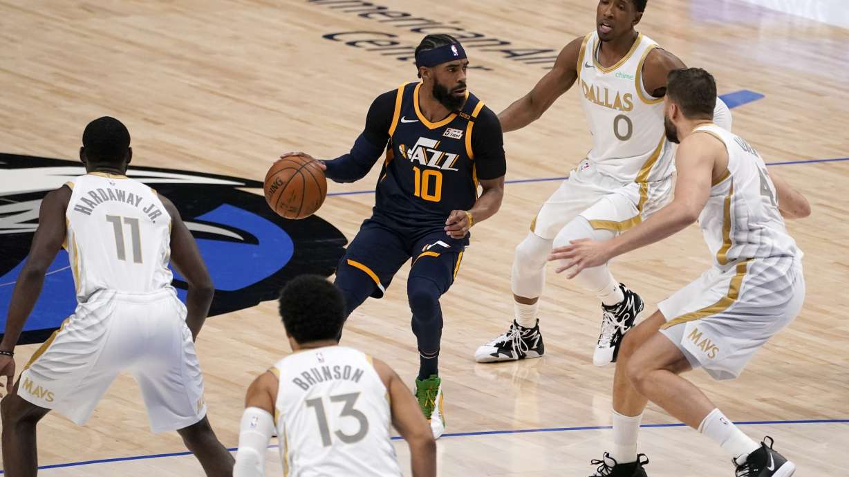 Utah Jazz guard Mike Conley (10) advances the ball upcourt as Dallas Mavericks' Tim Hardaway Jr. (11), Jalen Brunson (13), Maxi Kleber, right, and Josh Richardson (0) defend in the first half of an NBA basketball game in Dallas, Monday April 5, 2021. (AP Photo/Tony Gutierrez)