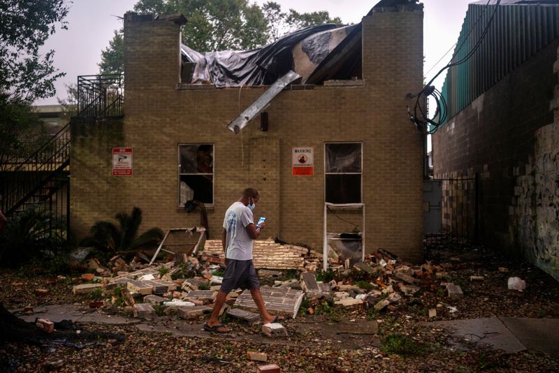 FILE PHOTO: Joel Martinez, who until just recently lived in the lower apartment, makes a photo of Washington Gardens Apartments after it collapsed from the winds brought by Hurricane Zeta in New Orleans, Louisiana, U.S. October 28, 2020.  REUTERS/Kathleen Flynn/File Photo