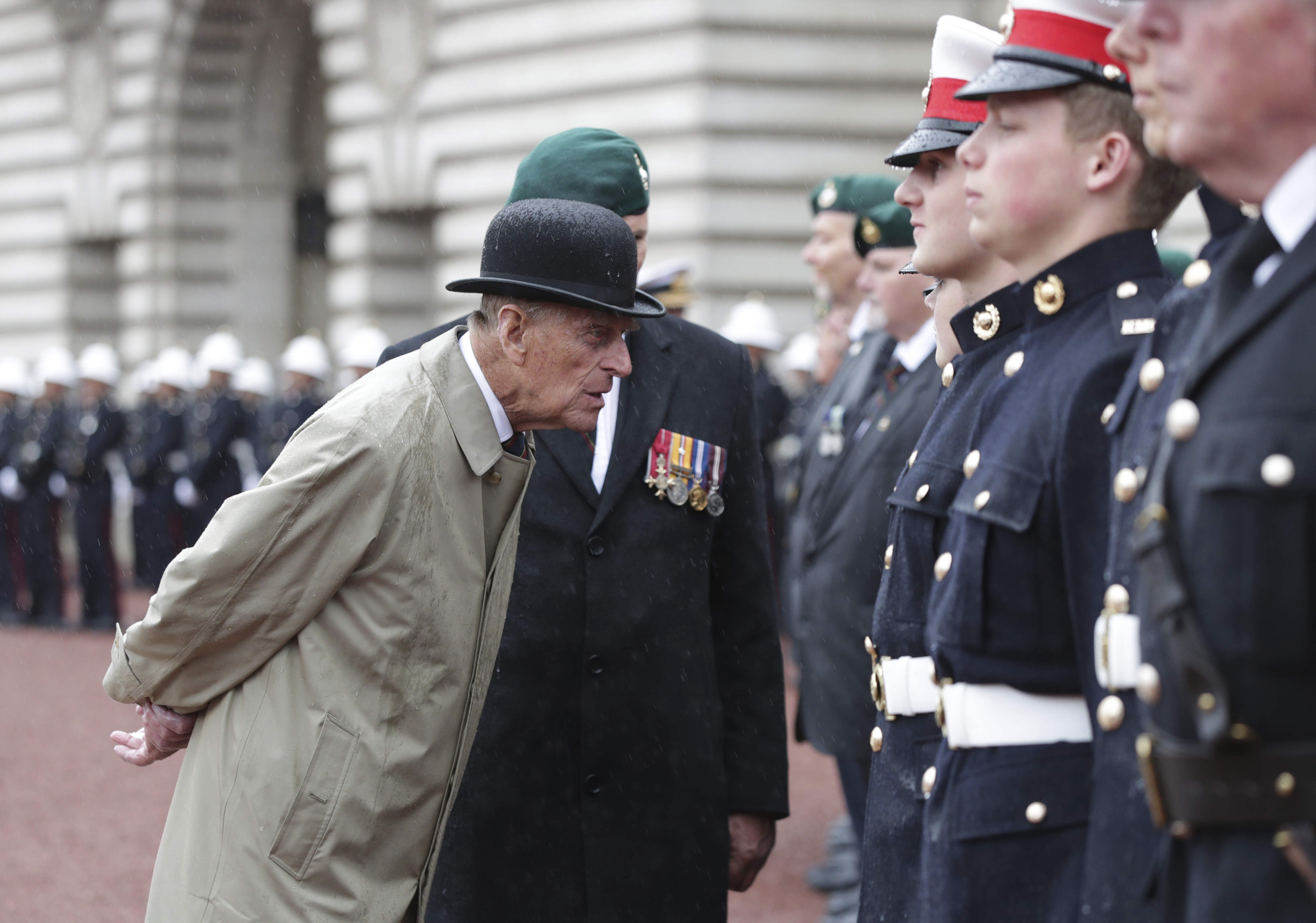 FILE - In this Wednesday Aug. 2, 2017 file photo, Britain's Prince Philip, in his role as Captain General of the Royal Marines, talks to troops as he attends a Parade on the forecourt of Buckingham Palace, in central London.