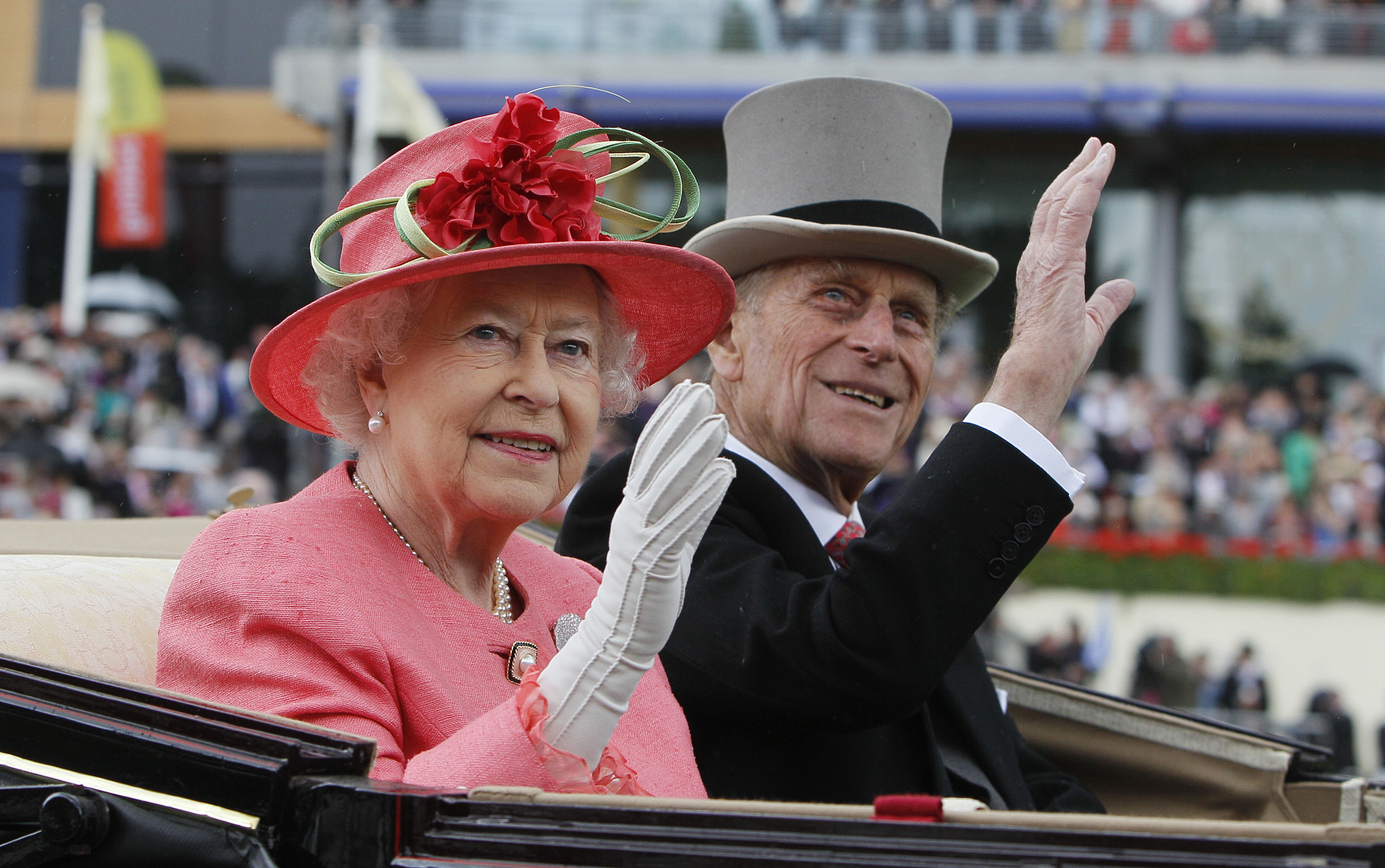 FILE - In this Thursday June, 16, 2011 file photo Britain's Queen Elizabeth II with Prince Philip arrive by horse drawn carriage in the parade ring on the third day, traditionally known as Ladies Day, of the Royal Ascot horse race meeting at Ascot, England.