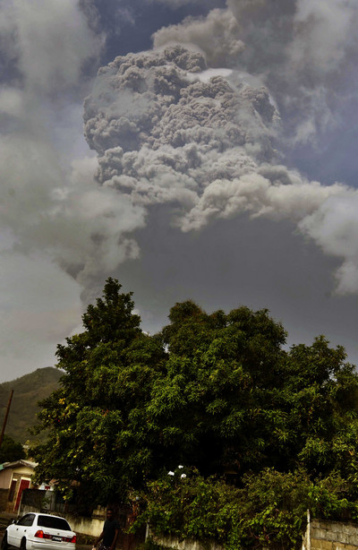 Plumes of ash rise from the La Soufriere volcano as it erupts on the eastern Caribbean island of St. Vincent, as seen from Chateaubelair, Friday, April 9, 2021.
