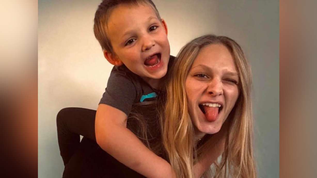 Arianne Brown's oldest daughter poses for a picture with one of her toddler sons.