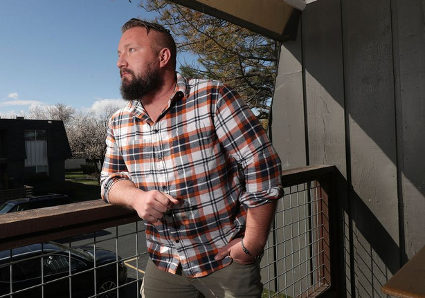 COVID-19 long-hauler Zeb Williams stands on the balcony of his apartment in Bountiful on Tuesday, March 30, 2021.