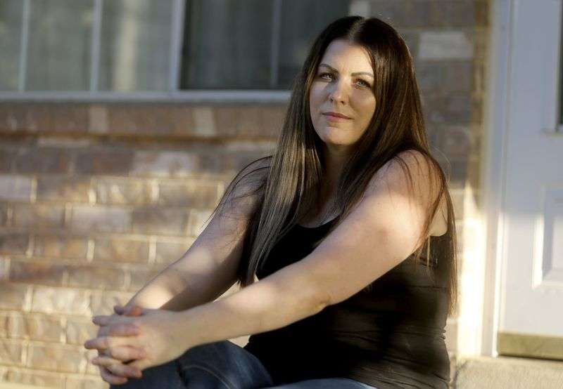 Lisa O’Brien poses for a portrait outside her home in Roy on Monday, Aug. 17, 2020. O’Brien created a Long Haulers Facebook group after getting sick with what she believes was COVID-19 early in the pandemic.