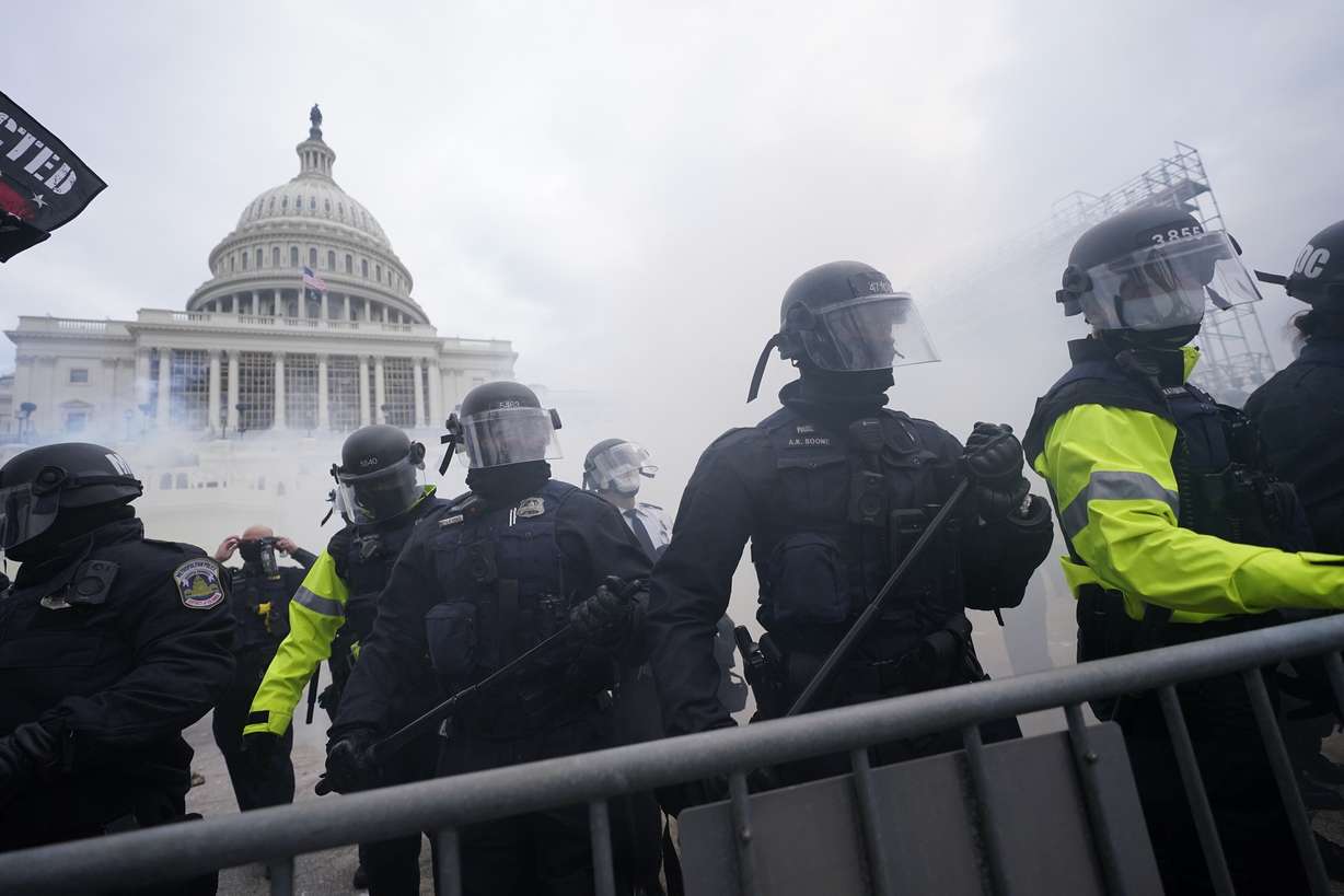 FILE - In this Jan. 6, 2021, file photo, police stand guard after holding off violent rioters who tried to break through a police barrier at the Capitol in Washington.