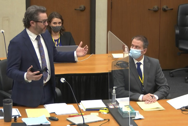 In this image from video, defense attorney Eric Nelson, left, discusses motions before the court as defendant, former Minneapolis police officer Derek Chauvin, right, and Nelson's assistant Amy Voss, back, listen, Monday, April 12, 2021, as Hennepin County Judge Peter Cahill presides over the trial of Chauvin at the Hennepin County Courthouse in Minneapolis.