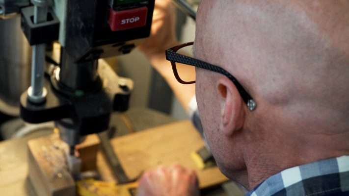 Darin Kirkham uses a drill to shape the center of one of his pens.