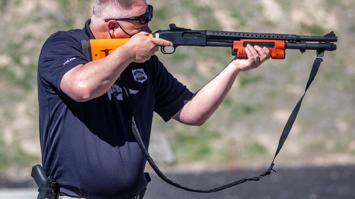 Salt Lake police detective Greg Wilking demonstrates a
new less-lethal shotgun at the Salt Lake City Police Airport
Training Facility in Salt Lake City on Monday, April 12, 2021.