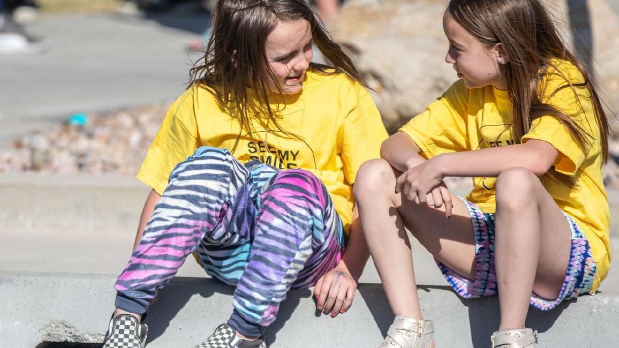 Children talk at the See My Smile rally against
masks in schools at the Jordan School District Office in West
Jordan on Saturday, April 10, 2021.