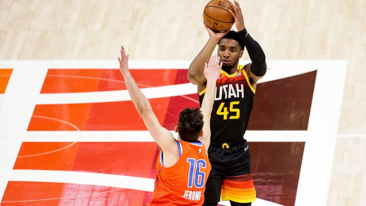 Utah Jazz guard Donovan Mitchell (45) shoots over Oklahoma City Thunder guard Ty Jerome (16) during the game at Vivint Smart Home Arena in Salt Lake City on Tuesday, April 13, 2021.