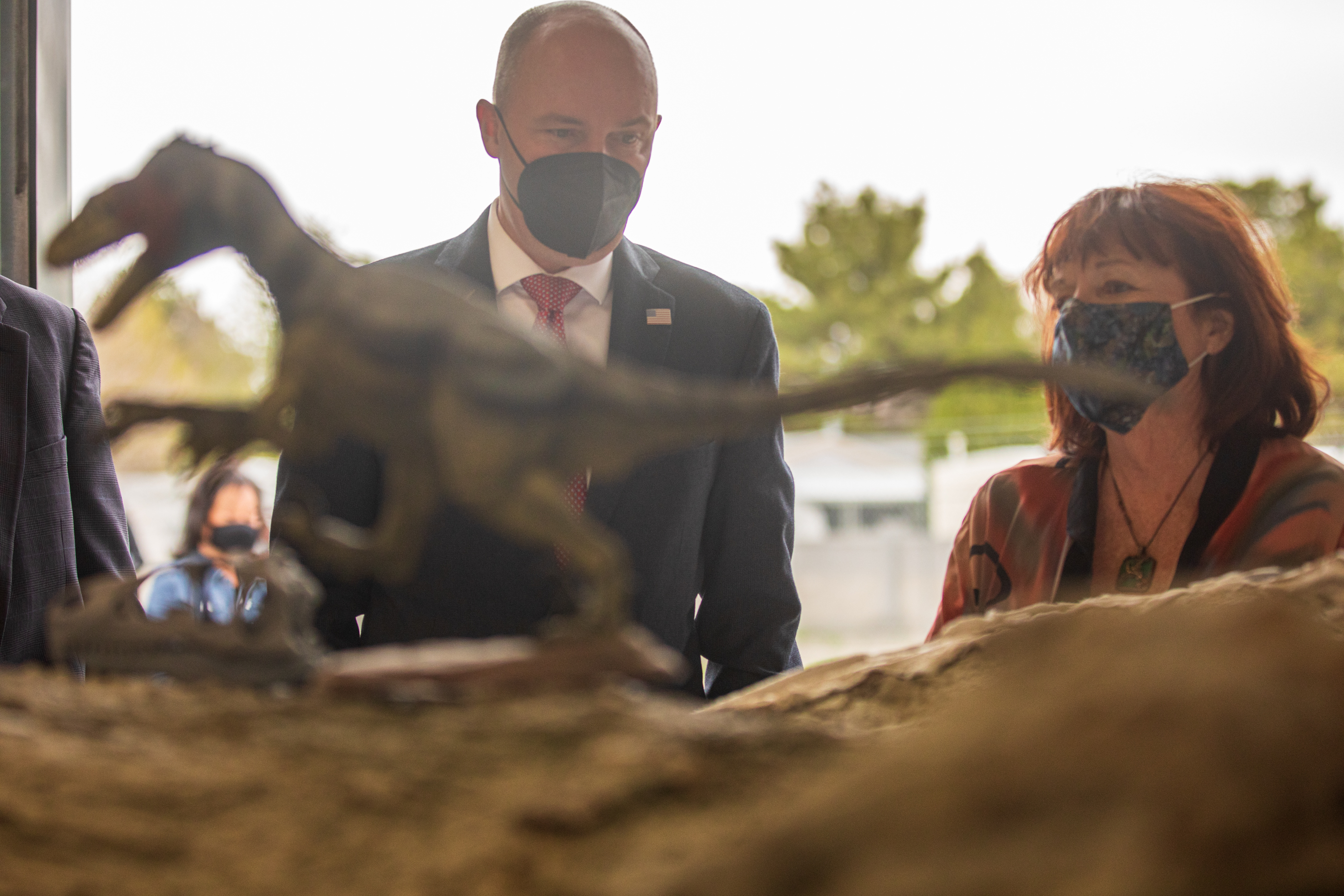 Gov. Spencer Cox, left, speaks with Grand County Commission Chair Mary McGann while they check out a Utahraptor megablock before a ceremony at the Utah Department of Natural Resources facility in Salt Lake City on Tuesday, April 13, 2021.