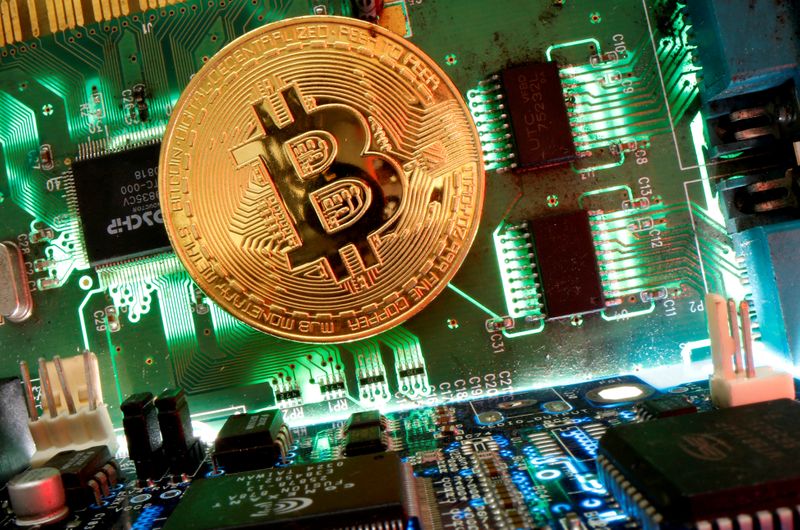 FILE PHOTO: Representation of the virtual currency Bitcoin is seen on a motherboard in this picture illustration taken April 24, 2020. REUTERS/Dado Ruvic/Illustration/File Photo