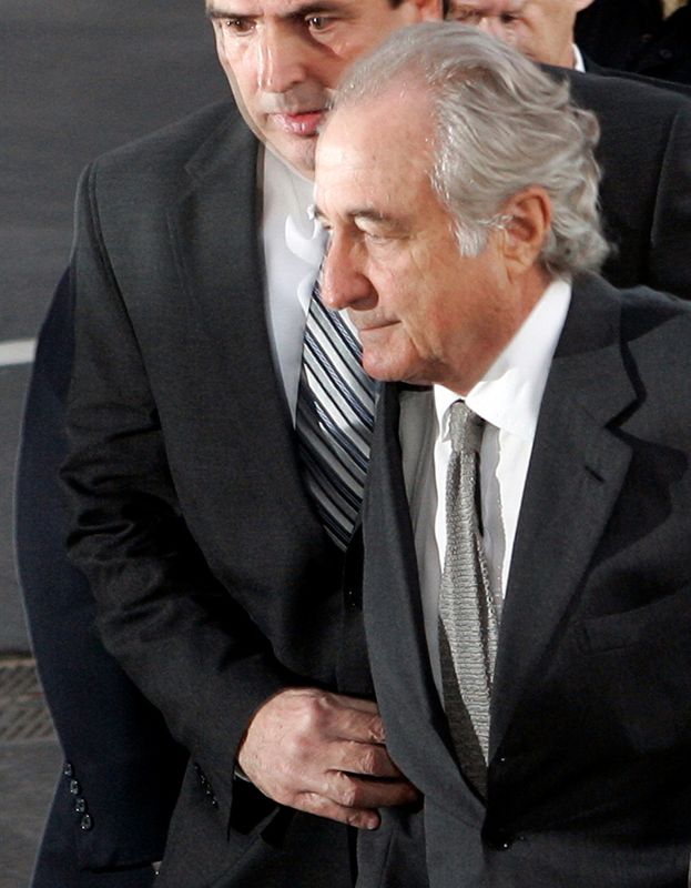 FILE PHOTO: Accused swindler Bernard Madoff (bottom) enters the Manhattan federal court house in New York March 12, 2009.  REUTERS/Shannon Stapleton/File Photo