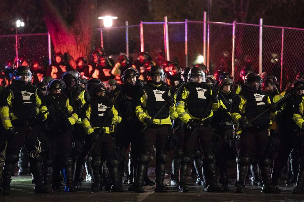 Authorities advance on demonstrators gathered outside the Brooklyn Center Police Department to protest the shooting death of Daunte Wright, late Tuesday, April 13, 2021, in Brooklyn Center, Minn.