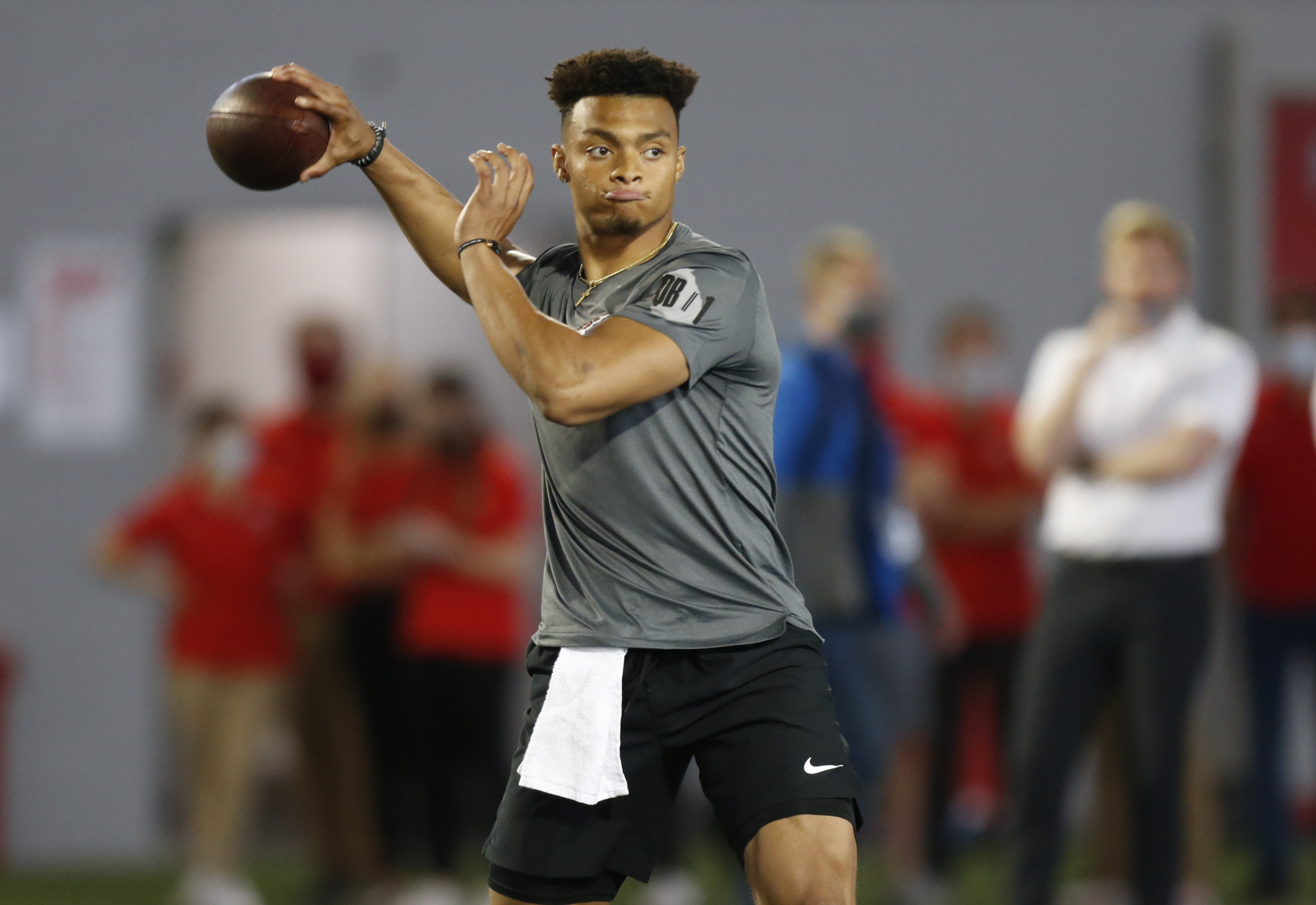 FILE - Ohio State quarterback Justin Fields throws during an NFL Pro Day at Ohio State University in Columbus, Ohio, in this Tuesday, March 30, 2021, file photo. The Division I Council meets Wednesday and Thursday, April 14-15, and at the top of the agenda — at least in terms of importance — is voting on a proposal that would grant all college athletes the right to transfer one time as undergraduates without sitting out season of competition. Some high-profile players such as quarterback Justin Fields, who transferred from Georgia to Ohio State in 2019, were granted waivers by the NCAA and it created an expectation that all players would be cleared to play right away. (AP Photo/Paul Vernon, File) [Apr-14-2021]