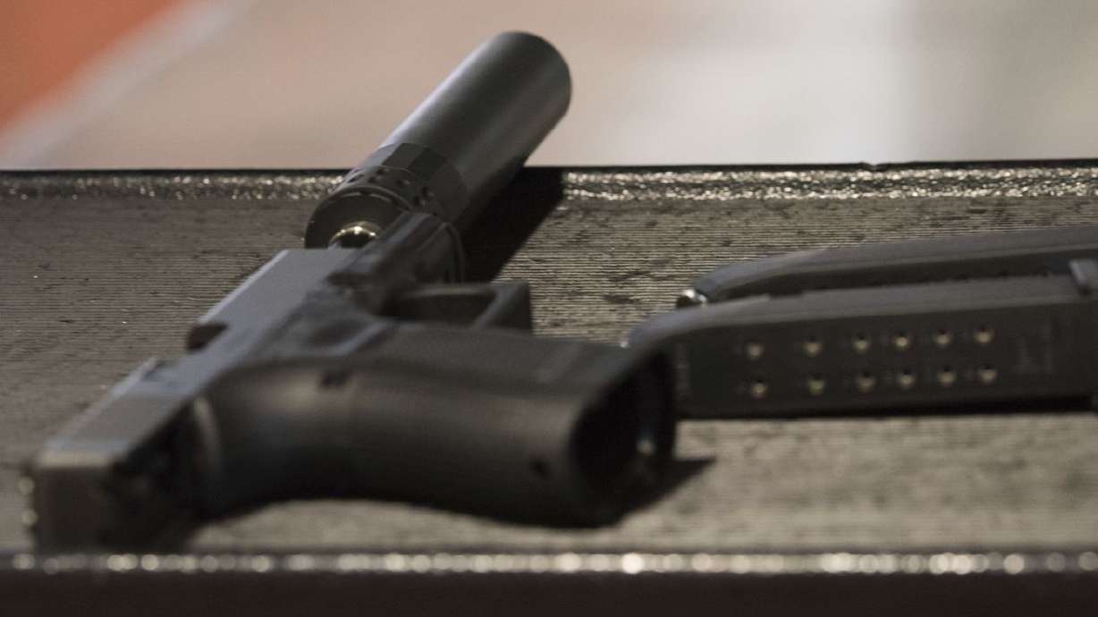 A handgun with a silencer and two magazines are shown
at a gun range in Atlanta on Jan. 27, 2017. While congressional
Democrats look for ways to tighten federal gun laws in the wake of
several mass shootings across the country, a group of Republicans,
led by Utah Sen. Mike Lee, want to undo regulations on silencers.