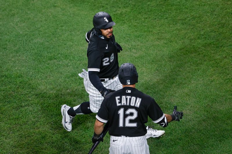Apr 14, 2021; Chicago, Illinois, USA; Chicago White Sox left fielder Leury Garcia (28) celebrates with right fielder Adam Eaton (12) after scoring against the Cleveland Indians during the first inning at Guaranteed Rate Field. Mandatory Credit: Kamil Krzaczynski-USA TODAY Sports