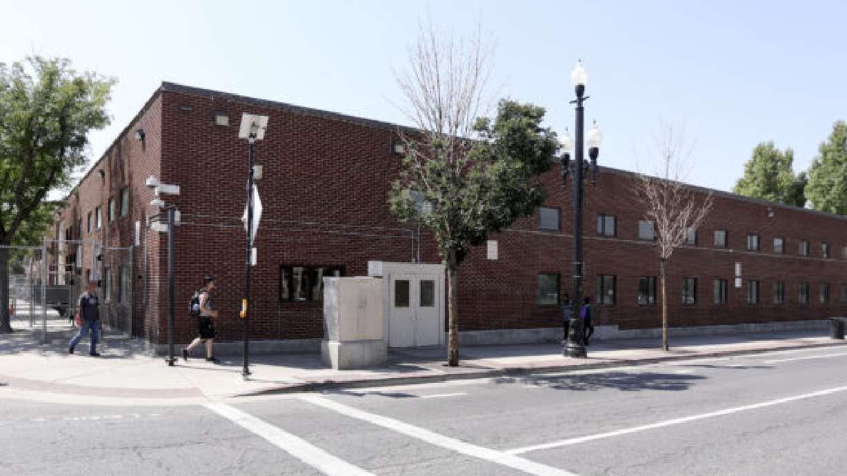 People walk in front of The Road Home in Salt Lake City on Wednesday, Aug. 8, 2018.