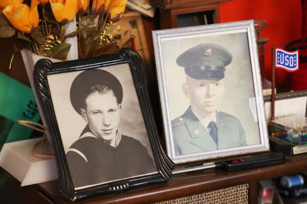 Military photos of Ken Potts and his son Wayne at his home in Provo Thursday, Nov. 17, 2016. Potts is one of five men still alive who served on the USS Arizona during the attack Dec. 7, 1941.