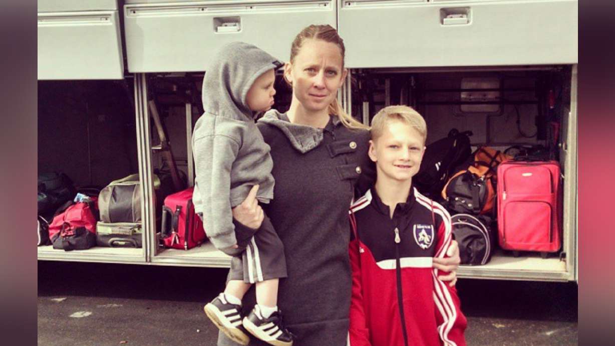 Arianne Brown stands with her oldest son when he left on his first out-of-state tournament in 2014.