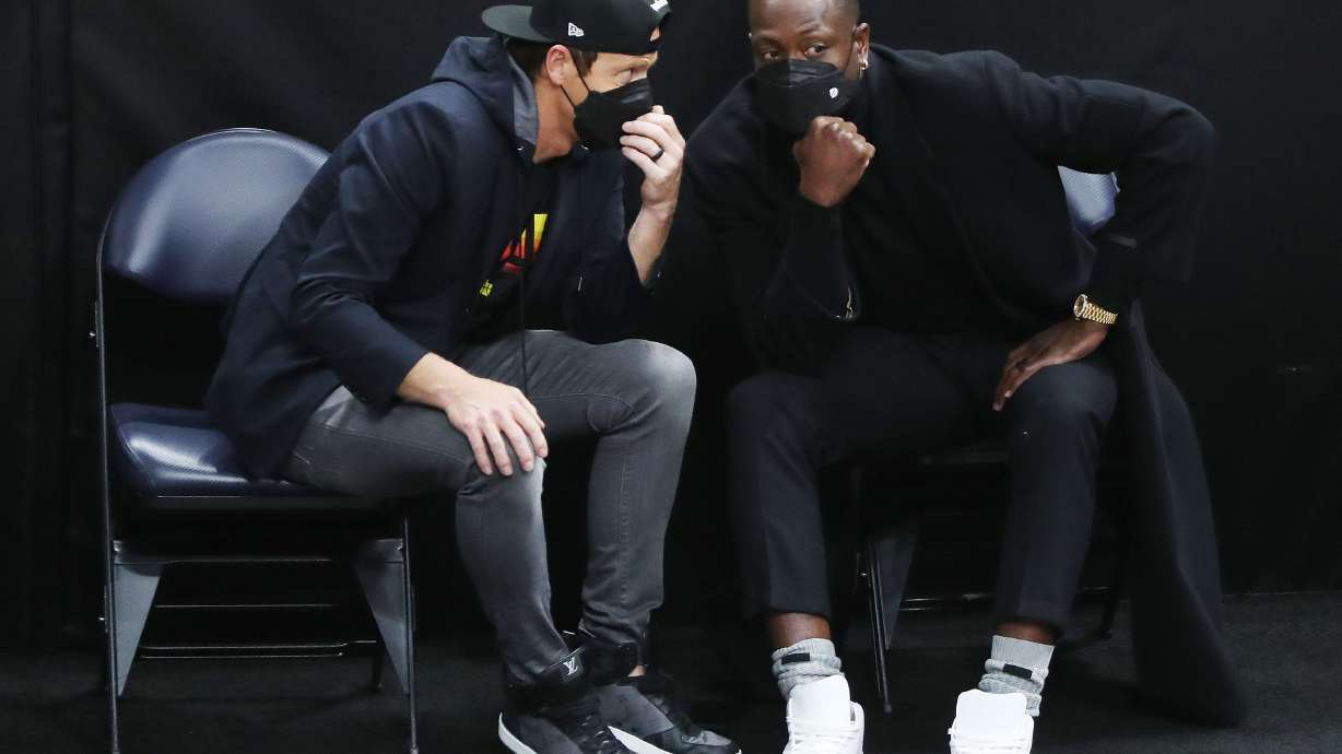 Utah Jazz owner Ryan Smith, left, and Dwayne Wade, who bought a share of the team, talk during a game at the Vivint Arena in Salt Lake City on Friday, April 16, 2021.