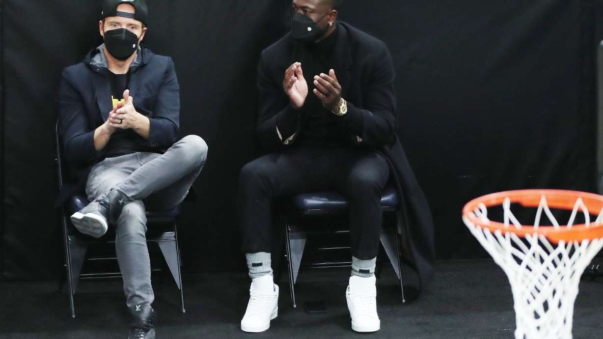 Utah Jazz owner Ryan Smith, left, and Dwayne Wade, who bought a share of the team, talk during a game at the Vivint Arena in Salt Lake City on Friday, April 16, 2021.