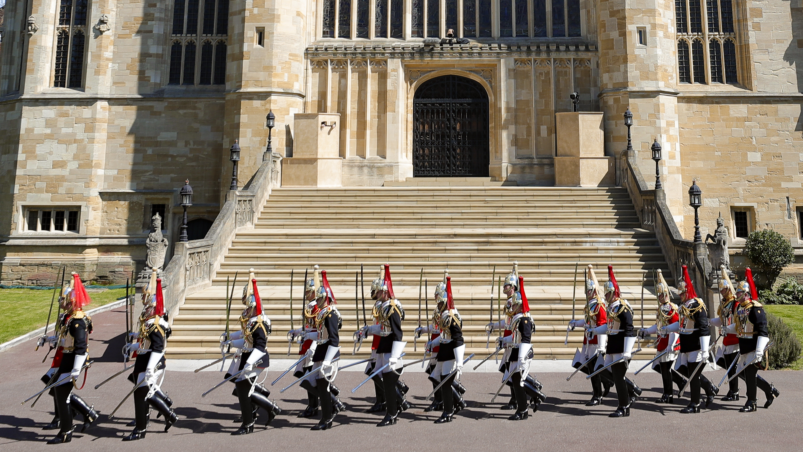 Members of Household Cavalry march by St George's Chapel before the funeral of Britain's Prince Philip inside Windsor Castle in Windsor, England, Saturday, April 17, 2021. (Kirsty Wigglesworth/Pool via AP) [Apr-17-2021]