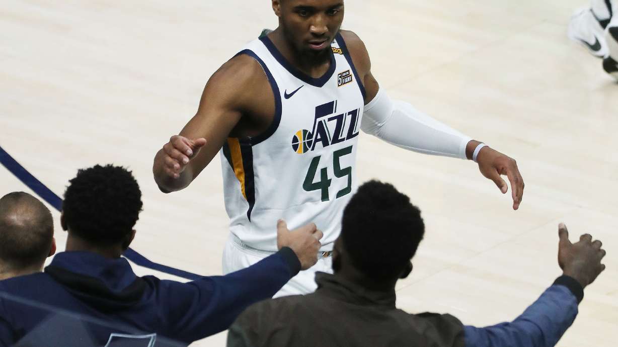 Utah Jazz guard Donovan Mitchell (45) high fives teammates during a game at the Vivint Arena in Salt Lake City on Friday, April 16, 2021.
