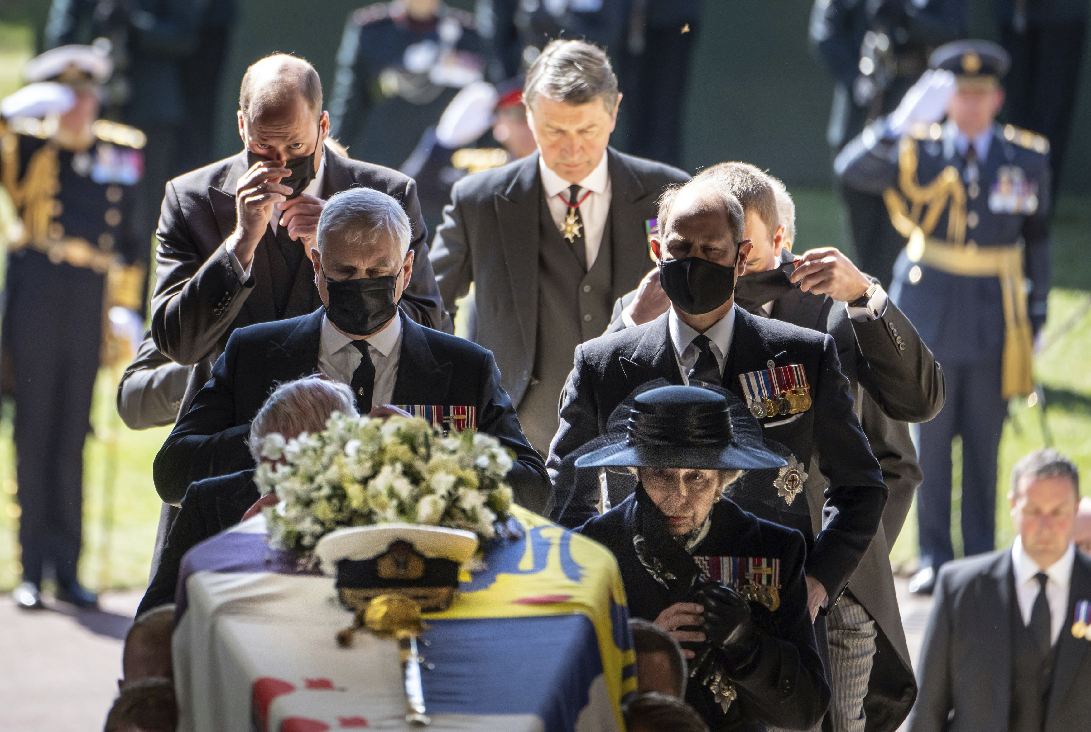 Pall Bearers carry the coffin of the Duke of Edinburgh into St George's Chapel for his funeral, as members of the royal family including Princess Anne, right, Prince Andrew, Prince Edward, Prince William and Sir Tim Laurence follow, at Windsor Castle, in Windsor, England, Saturday April 17, 2021. Prince Philip died April 9 at the age of 99 after 73 years of marriage to Britain's Queen Elizabeth II. (Danny Lawson/Pool via AP) [Apr-17-2021]