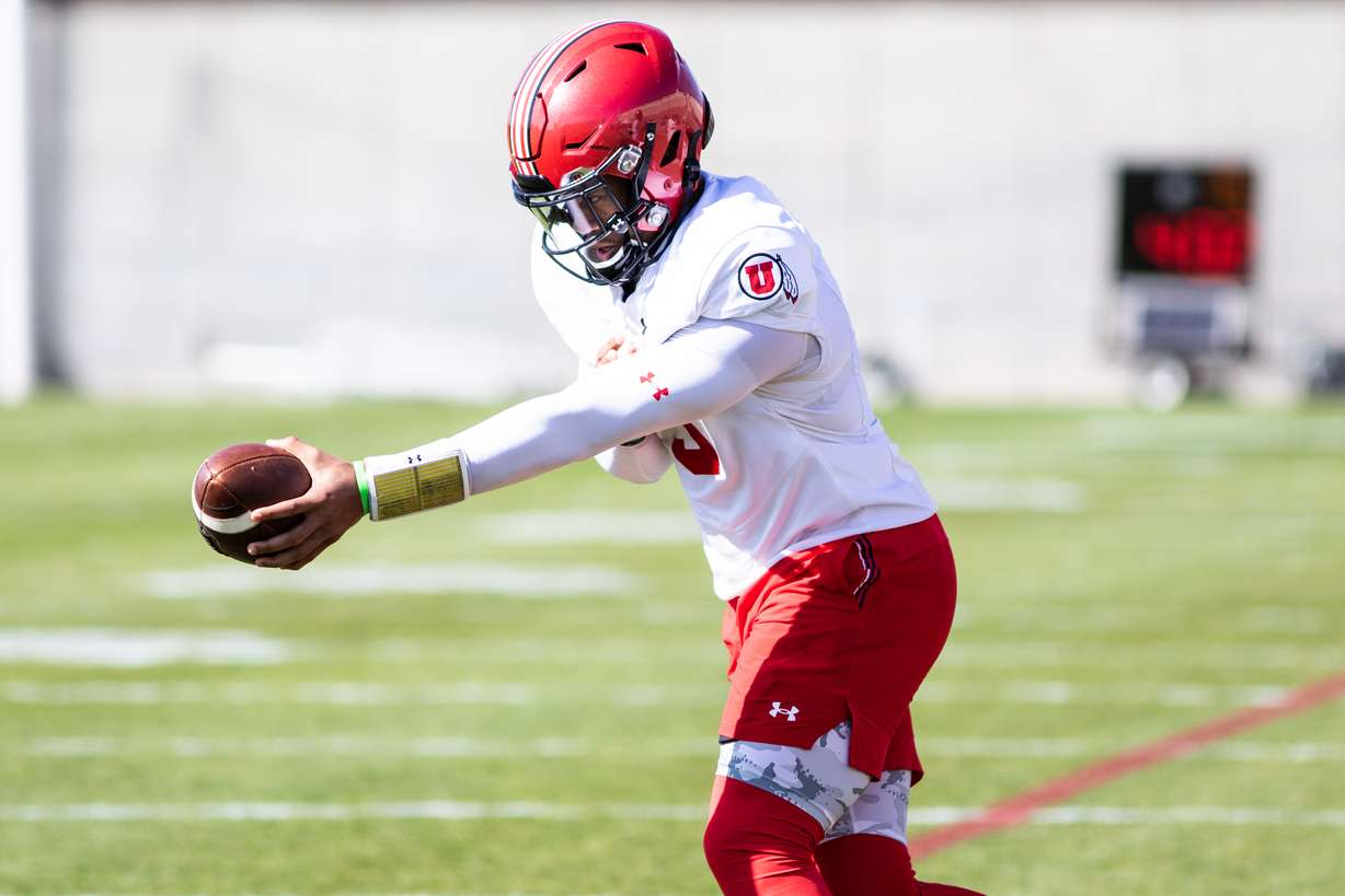 Ja'Quinden Jackson practices hand-off drills during spring camp at Rice-Eccles Stadium.