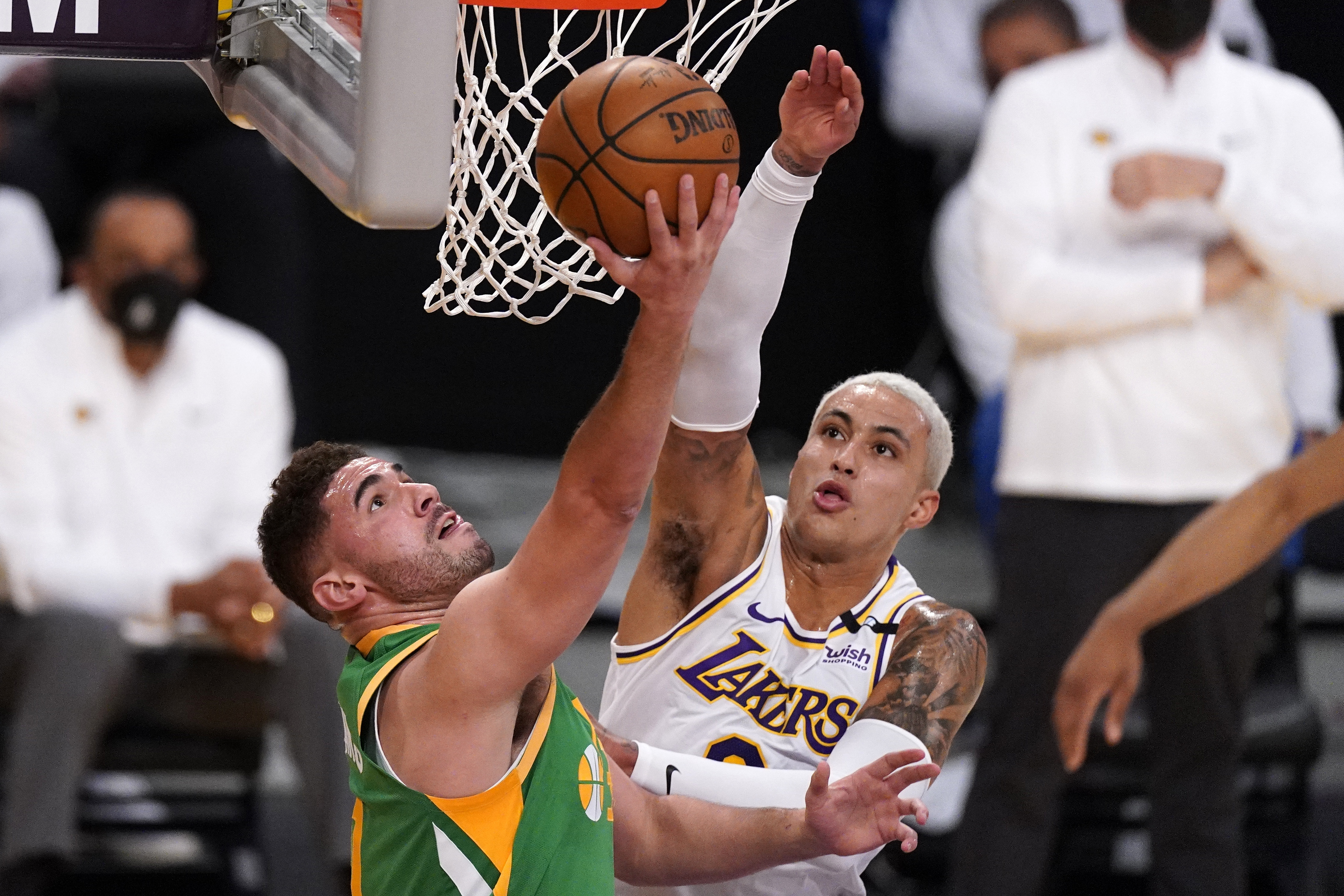 Utah Jazz forward Georges Niang, left, shoots as Los Angeles Lakers forward Kyle Kuzma defends during the first half of an NBA basketball game Saturday, April 17, 2021, in Los Angeles.