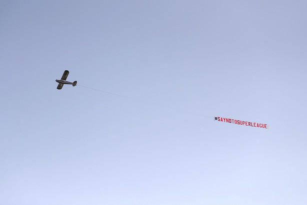 A plane with a 'Say No To Super League' banner flies over Elland Road, as a protest against Liverpool's decision to be included amongst the clubs attempting to form a new European Super League, in Leeds, England, Monday, April 19, 2021. Reaction to the proposals from 12 clubs to rip up European soccer by forming a breakaway Super League has ranged from anger and condemnation to humor and sarcasm.