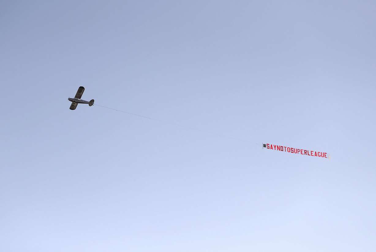 A plane with a 'Say No To Super League' banner flies over Elland Road, as a protest against Liverpool's decision to be included amongst the clubs attempting to form a new European Super League, in Leeds, England, Monday, April 19, 2021. Reaction to the proposals from 12 clubs to rip up European soccer by forming a breakaway Super League has ranged from anger and condemnation to humor and sarcasm.