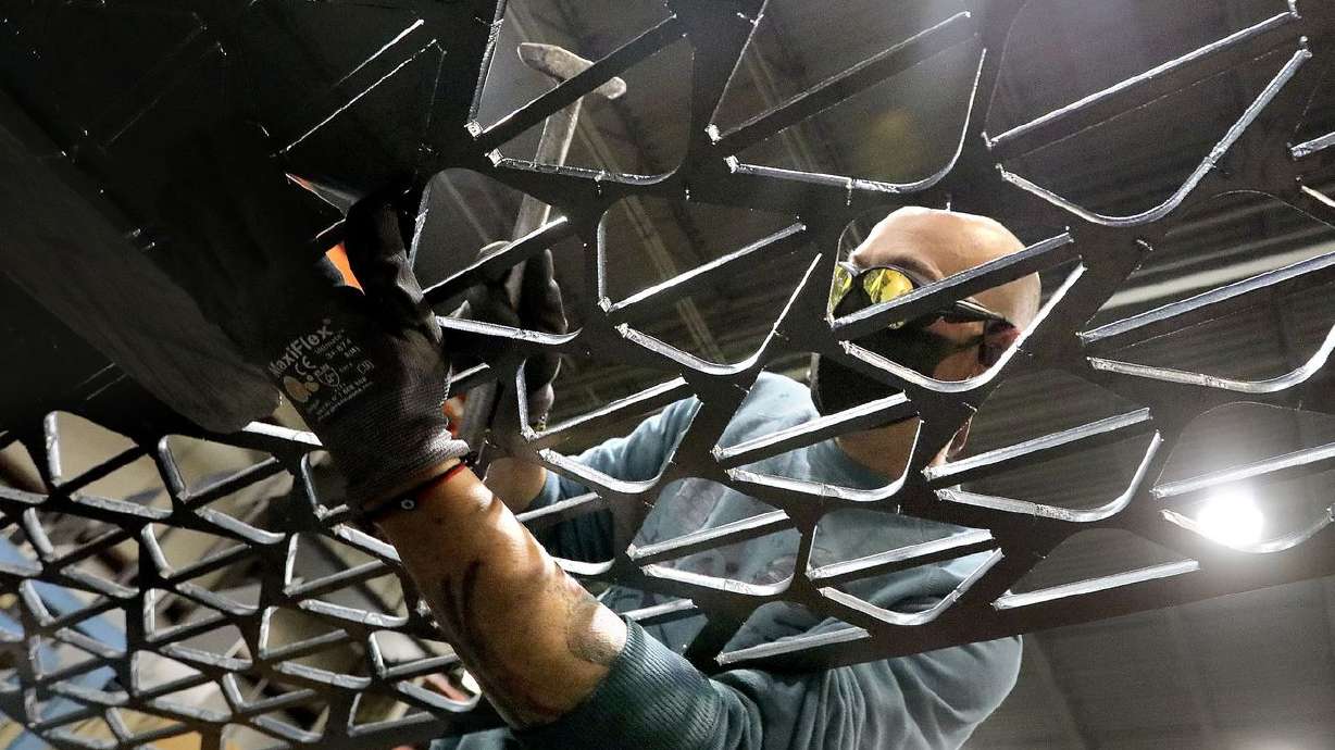 Laser operator Diego Maquiola hammers out assembly
pieces for a flight simulator tower at Complex Fabricators in Salt
Lake City on Tuesday, April 6, 2021.