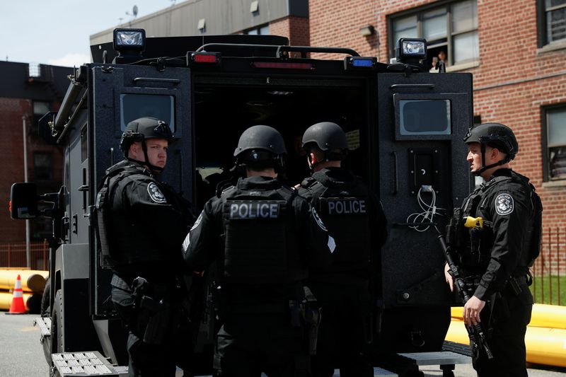 Law enforcement officers stand near the place where the shooter barricaded himself, after a shooting at a Stop and Shop grocery store, in Hempstead, New York, U.S., April 20, 2021.  REUTERS/Shannon Stapleton