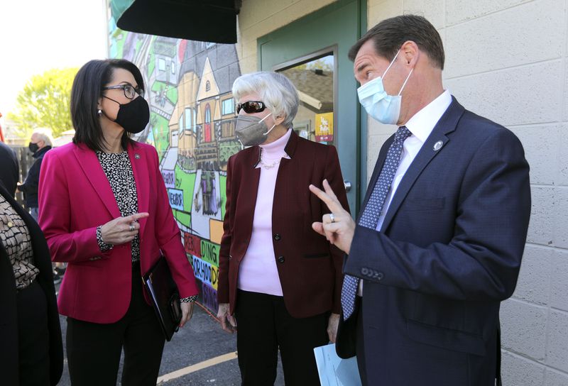 Lt. Gov. Deidre Henderson, left, Pamela Atkinson, adviser to the Gov. Spencer Cox, and Rep. Steve Eliason, R-Sandy, chat after Cox and Henderson ceremoniously signed six bills all aimed at "equity” by dealing with hunger, homelessness, immigration, housing affordability and language barriers, including
HB347, sponsored by Eliason, at NeighborWorks in Salt Lake City on
Tuesday, April 20, 2021.