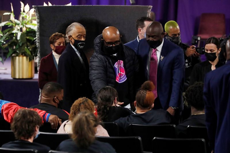 Rev. Al Sharpton, Terrence Floyd, the brother of the George Floyd and civil rights attorney Ben Crump pay their respects to Aubrey and Katie Wright, the parents of Daunte Wright during his viewing service, he was shot and killed by Brooklyn Center Police officer Kim Potter, at his public viewing at Shiloh Temple International Ministries in Minneapolis, Minnesota, U.S., April 21, 2021. REUTERS/Octavio Jones