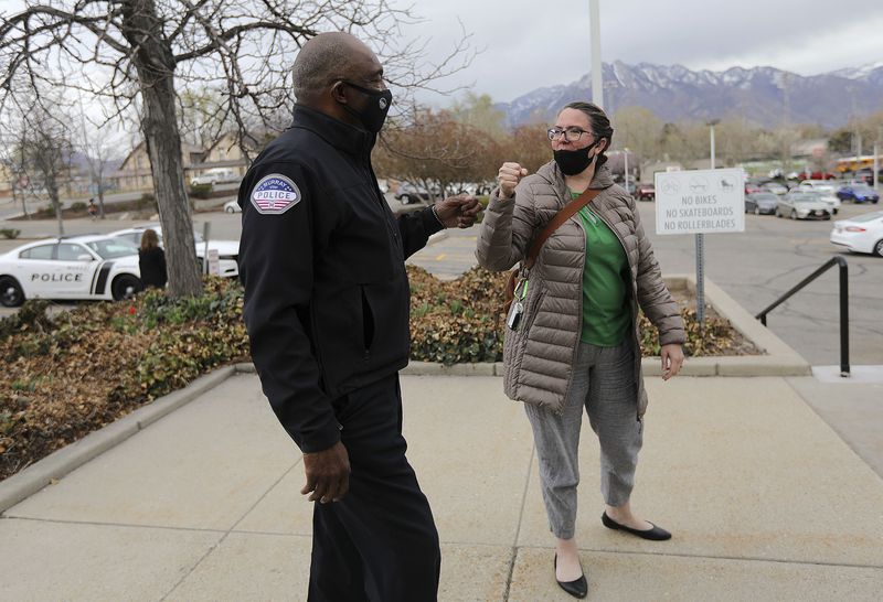 Murray Assistant Police Chief Joe Tarver gives a fist-bump to Jenefer Reudter, legal administrative supervisor for the Murray Attorney’s Office, in Murray on Tuesday, April 13, 2021. It was the first time they had seen each other since the announcement that Tarver is leaving the police department to become chief of investigations for the Salt Lake County District Attorney’s Office.