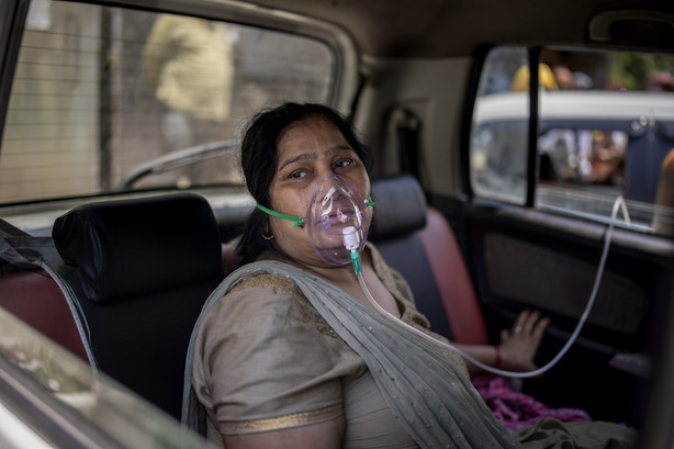 A COVID-19 patient sits inside a car and breathes with the help of oxygen provided by a Gurdwara, a Sikh house of worship, in New Delhi, India, Saturday, April 24, 2021.